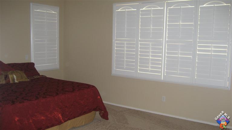 44741 Ruthron Avenue Lancaster, CA 93536 - Photo 13 of 18 a bedroom with a bed and a window