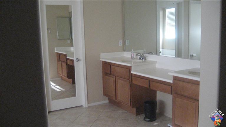 44741 Ruthron Avenue Lancaster, CA 93536 - Photo 14 of 18 a bathroom with a sink and a mirror