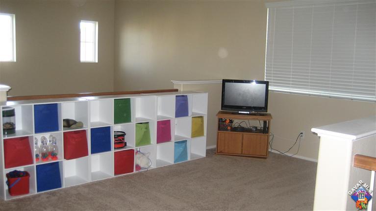 44741 Ruthron Avenue Lancaster, CA 93536 - Photo 16 of 18 a living room with furniture and a flat screen tv