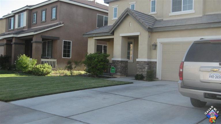 44741 Ruthron Avenue Lancaster, CA 93536 - Photo 3 of 18 a front view of a house with garden