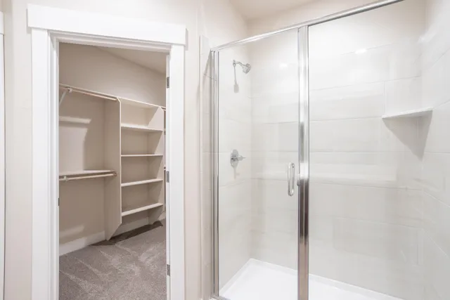a bathroom with a glass shower door
