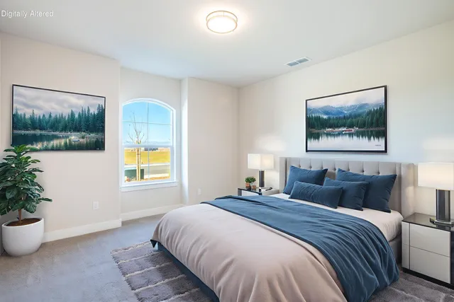 a bedroom with a bed and a painting on the wall