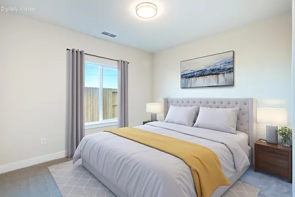 a bedroom with a bed and a painting on the wall