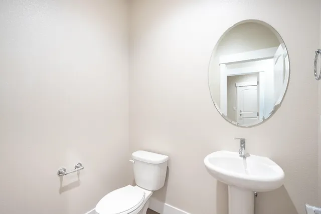 a bathroom with a sink a mirror and toilet