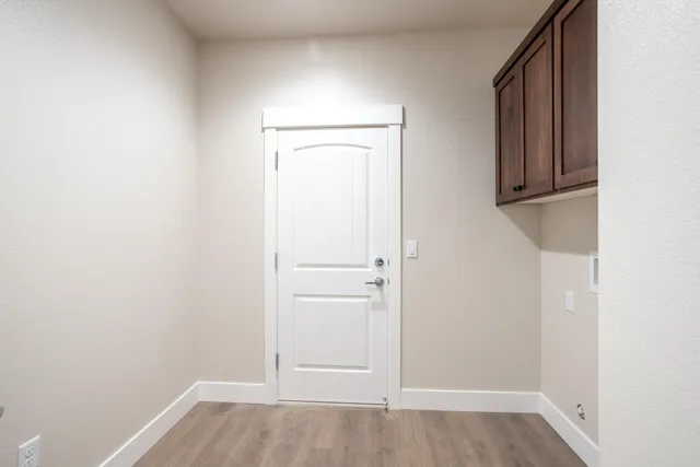an empty room with wooden floor