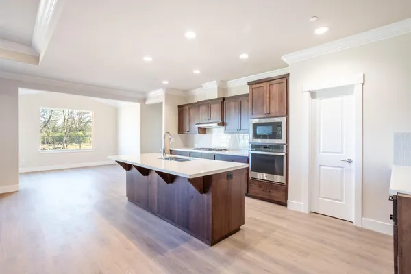a kitchen with stainless steel appliances granite countertop a stove and a refrigerator