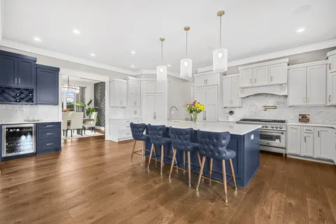 a view of kitchen with stainless steel appliances granite countertop cabinets dining table and chairs