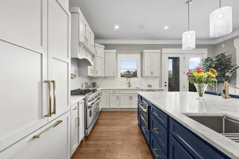 a kitchen with kitchen island granite countertop lots of counter top space and stainless steel appliances