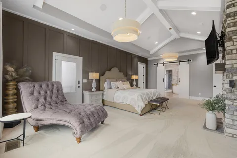 a spacious bedroom with a bed and a couch