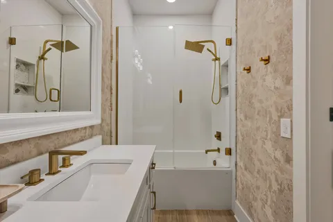 a bathroom with a bathtub and shower