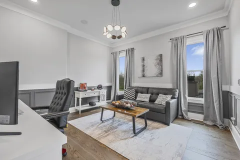 a living room with furniture and a chandelier