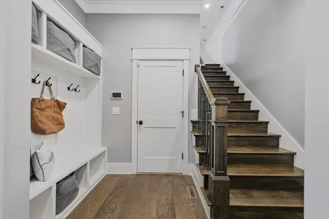 a view of entryway and hall with wooden floor