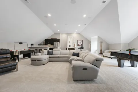 a living room with furniture and view of kitchen