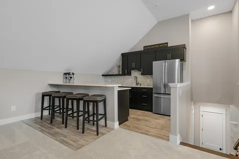 a kitchen with stainless steel appliances a refrigerator and a stove top oven