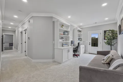 a living room with furniture and view of kitchen