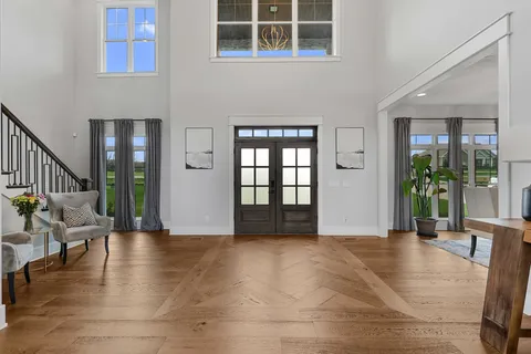 a view of an entryway with wooden floor and door