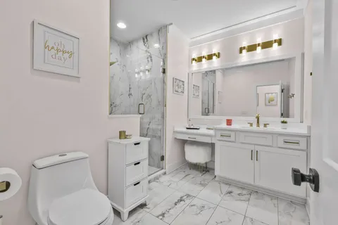 a bathroom with a sink toilet and shower