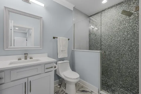 a bathroom with a sink toilet and mirror
