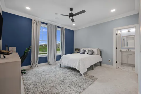 a spacious bedroom with a bed and a chandelier