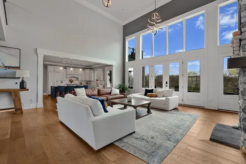 a living room with furniture rug and large windows