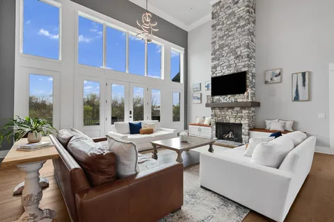a living room with furniture a fireplace and a flat screen tv
