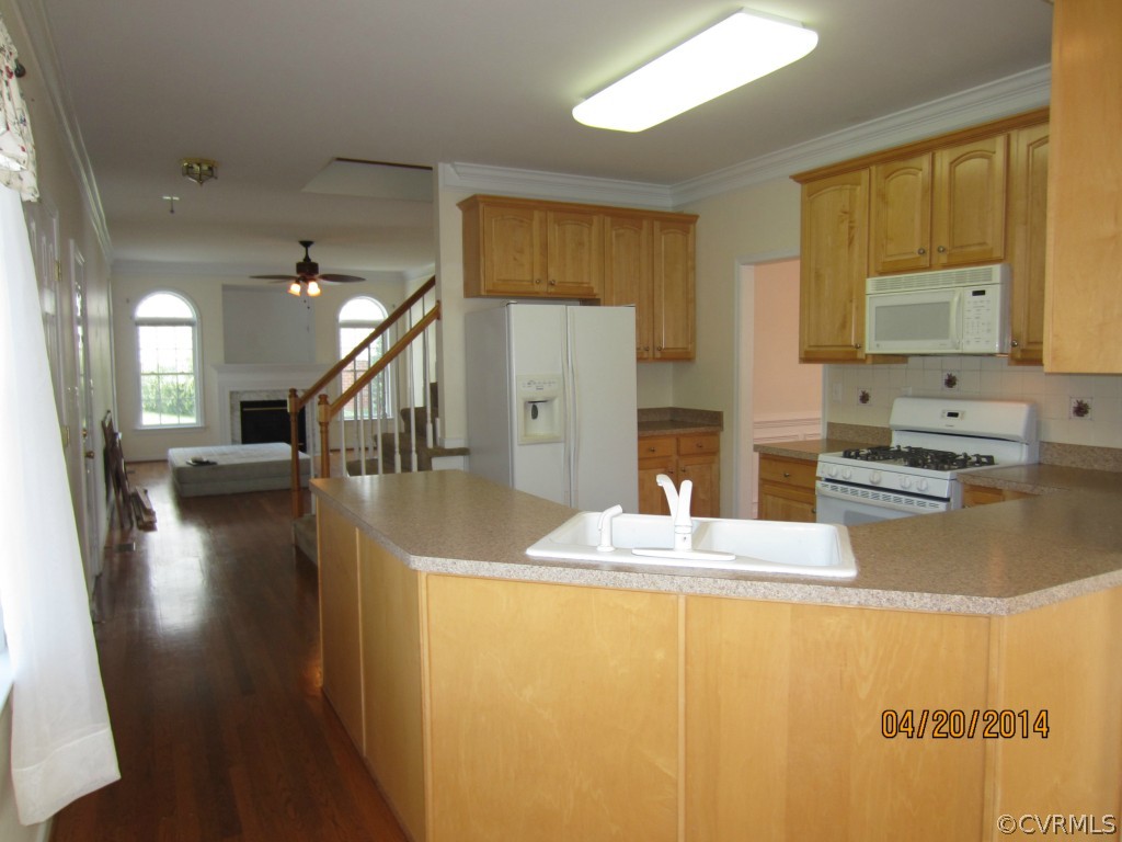 1443 Goswick Ridge Road Midlothian, VA 23114 - Photo 8 of 22 a kitchen with stainless steel appliances granite countertop a sink a stove top oven a chimney and a dining table view