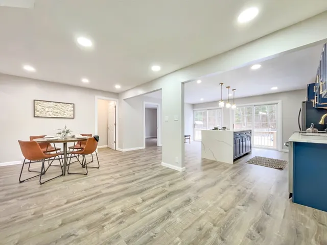 a view of a kitchen with furniture and wooden floor