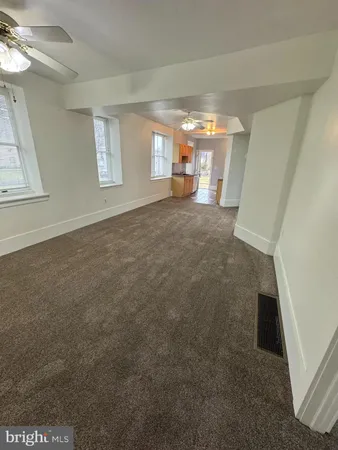 a view of empty room with window and fireplace