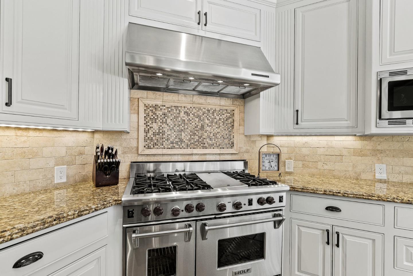 1405 Lakeview Court San Martin, CA 95046 - Photo 17 of 83 a kitchen with granite countertop white cabinets stainless steel appliances and a counter space