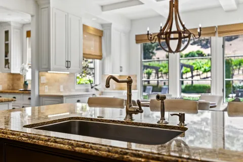 a spacious bathroom with a granite countertop tub sink a mirror a shower and vanity
