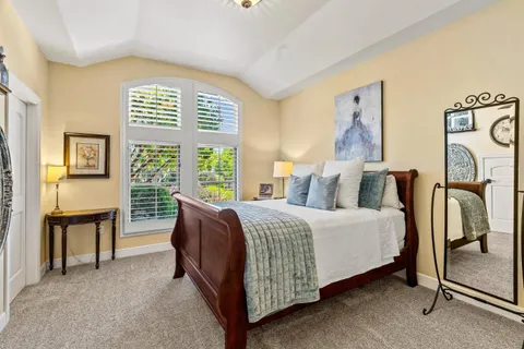 a spacious bedroom with a bed and a window