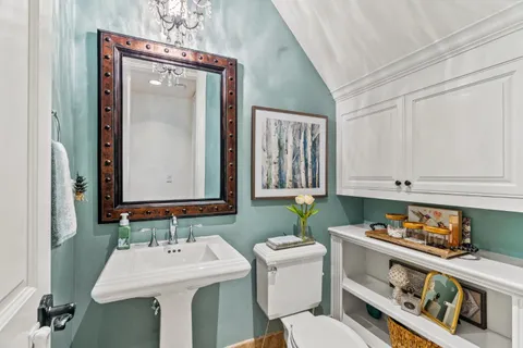 a bathroom with a bathtub shower sink vanity and toilet