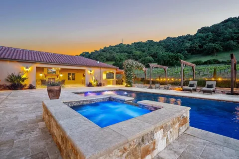 a view of house with yard and outdoor seating