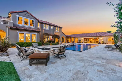 a kitchen with stainless steel appliances granite countertop a sink a stove and cabinets