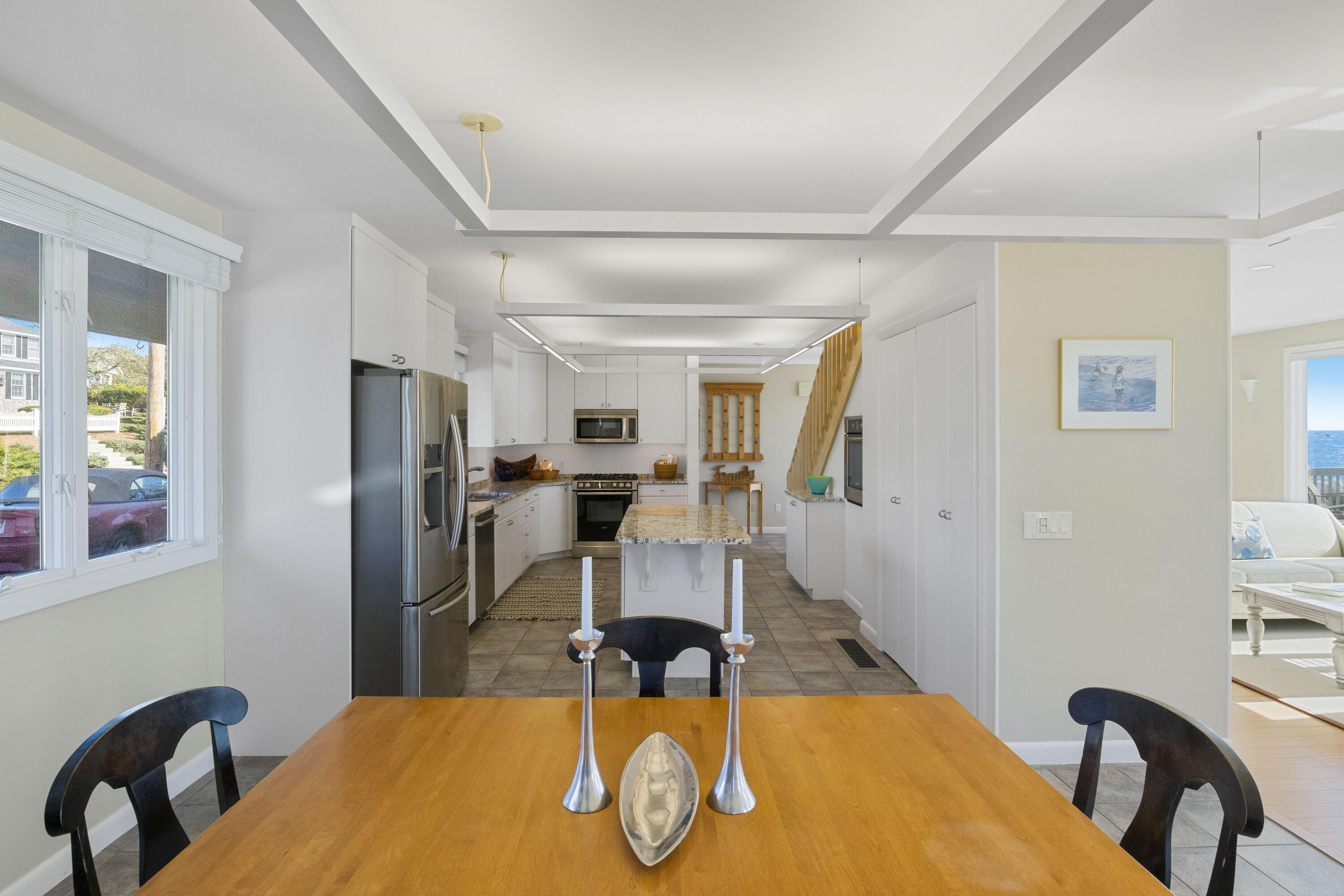 43 Shore Road West Harwich, MA 02671 - Photo 18 of 40 a kitchen with stainless steel appliances granite countertop a dining table chairs and refrigerator