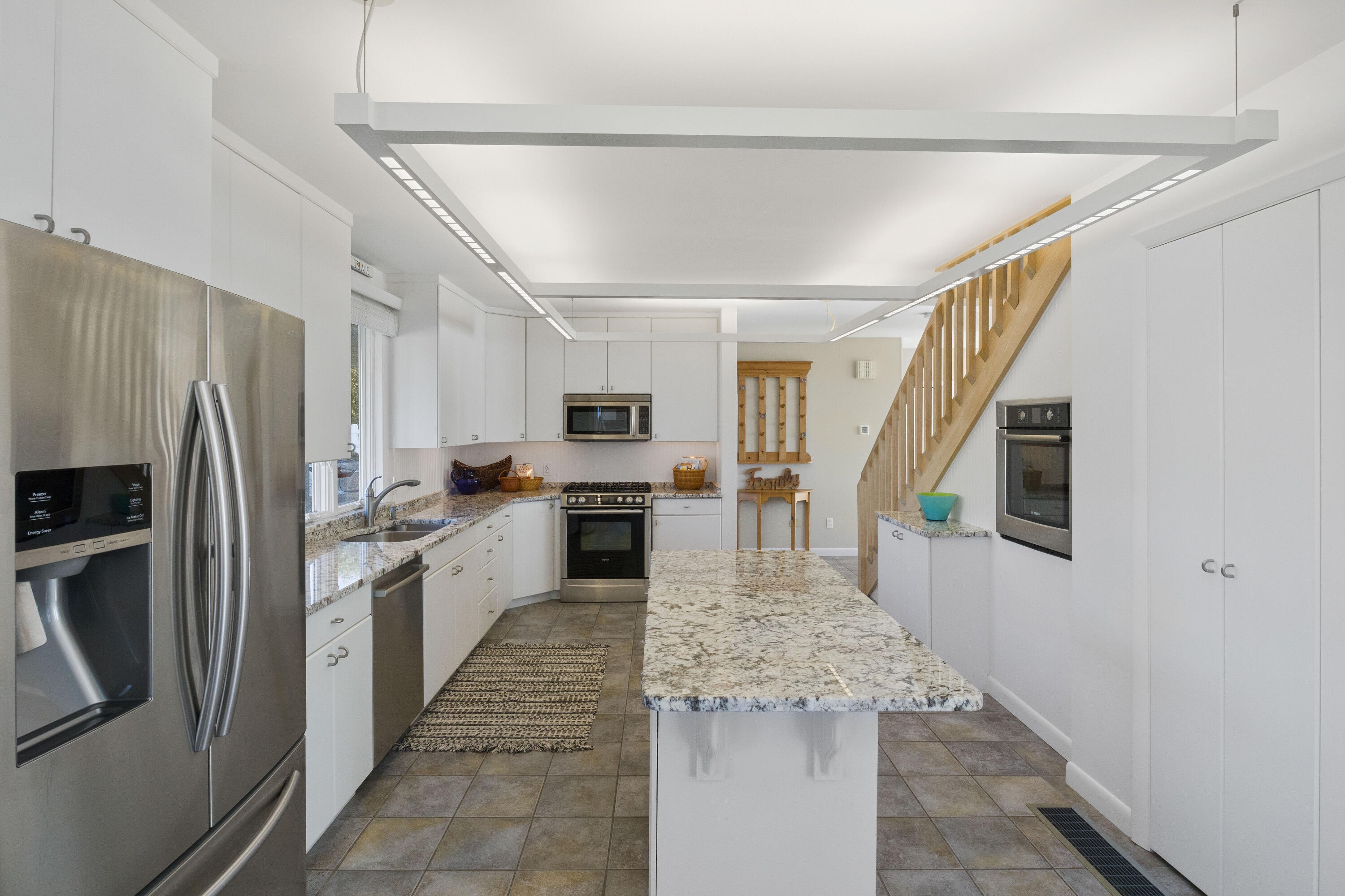 43 Shore Road West Harwich, MA 02671 - Photo 20 of 40 a kitchen with white cabinets and stainless steel appliances