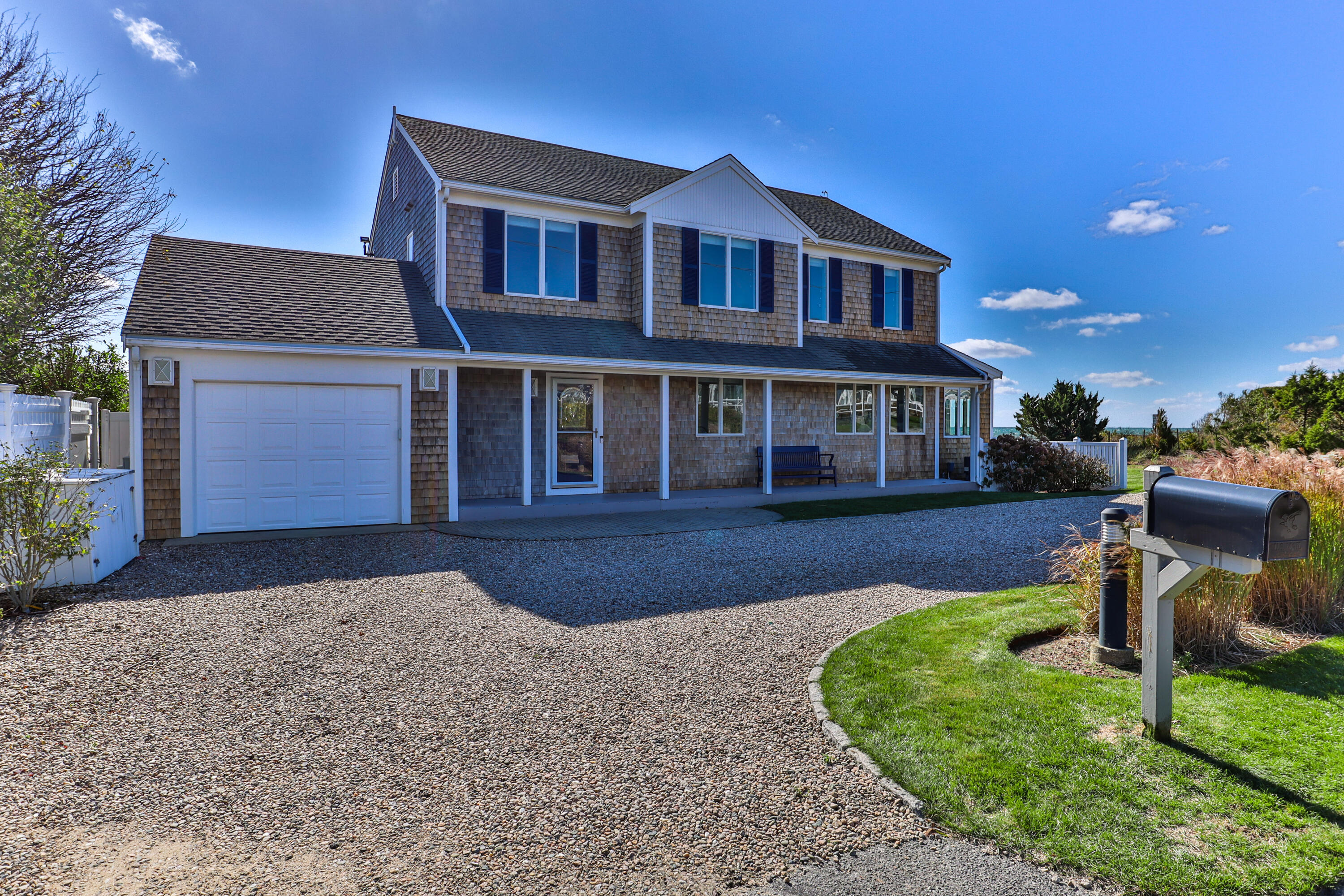 43 Shore Road West Harwich, MA 02671 - Photo 6 of 40 a front view of a house with a yard and porch