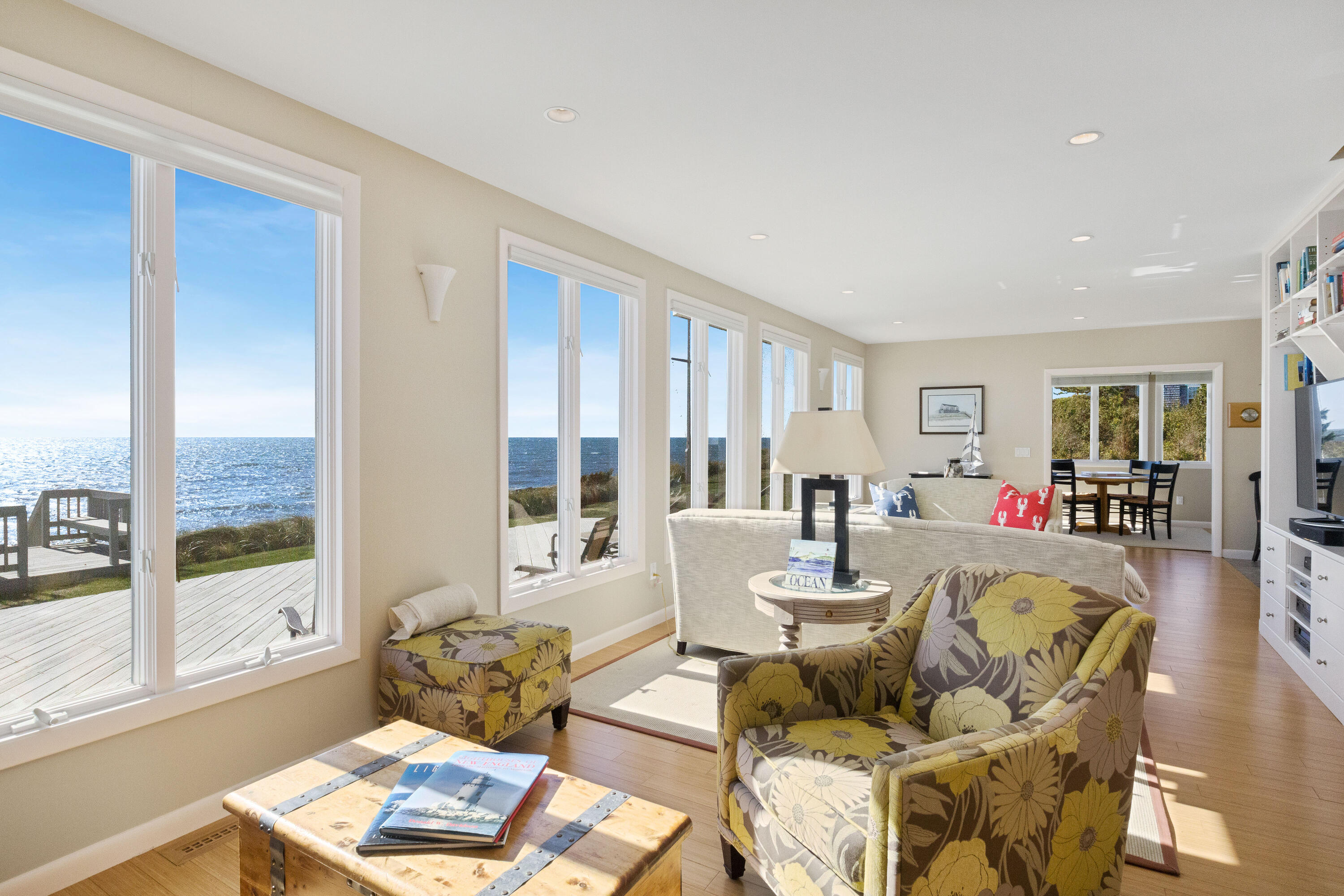 43 Shore Road West Harwich, MA 02671 - Photo 10 of 40 a living room with couches and a large window with garden view