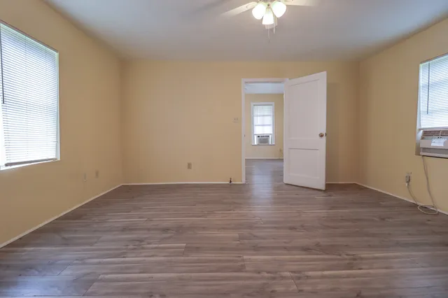 wooden floor in an empty room with a window