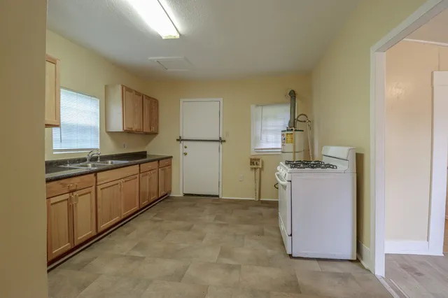 a kitchen with a refrigerator and white cabinets