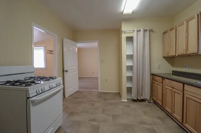 a kitchen with stainless steel appliances granite countertop a stove and a refrigerator