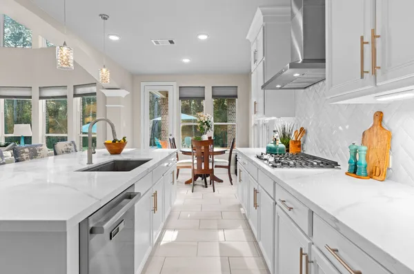 a kitchen with stainless steel appliances granite countertop a sink and cabinets