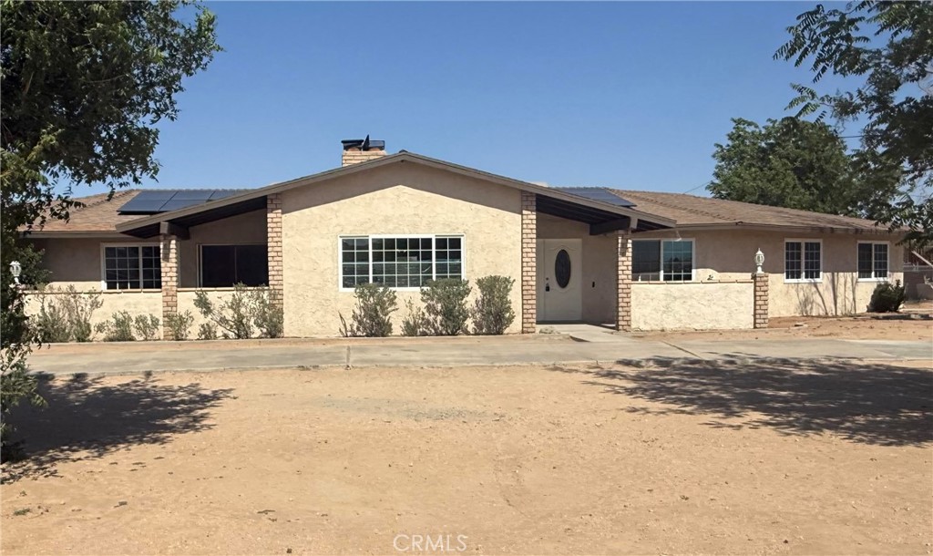 15615 Apache Road Apple Valley, CA 92307 - Photo 1 of 1 a front view of a house with a yard
