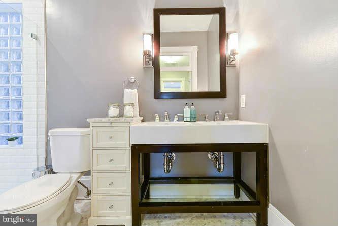 1319 T Street Northwest Washington, DC 20009 - Photo 13 of 25 a bathroom with a sink vanity mirror and toilet