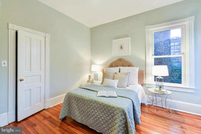 1319 T Street Northwest Washington, DC 20009 - Photo 19 of 25 a bedroom with a bed and wooden floor