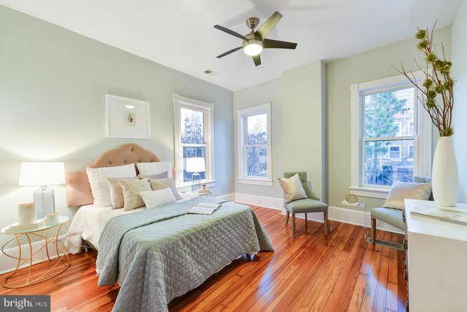 1319 T Street Northwest Washington, DC 20009 - Photo 20 of 25 a bedroom with a bed and wooden floor