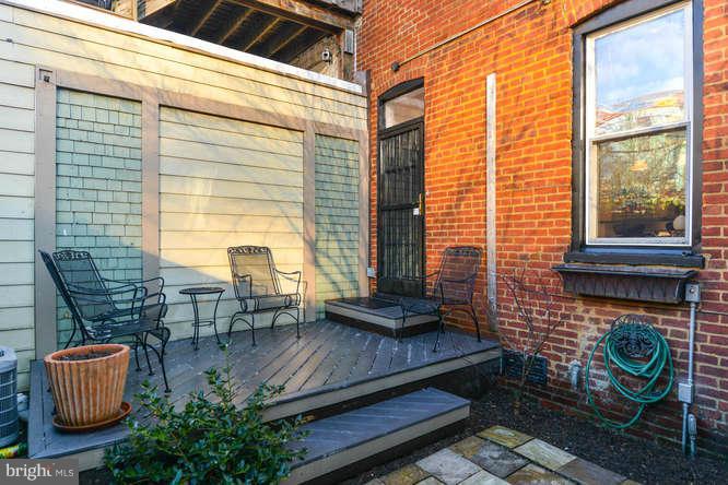 1319 T Street Northwest Washington, DC 20009 - Photo 21 of 25 a backyard of a house with barbeque oven table and chairs
