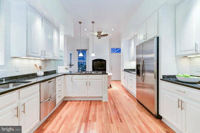 1319 T Street Northwest Washington, DC 20009 - Photo 8 of 25 a large kitchen with granite countertop a refrigerator and a stove top oven