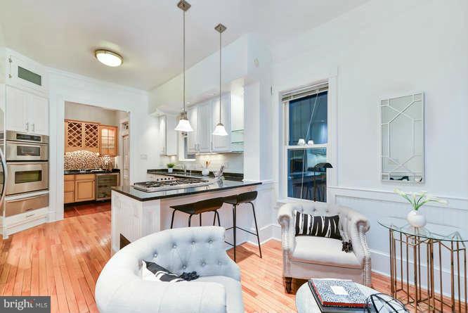 1319 T Street Northwest Washington, DC 20009 - Photo 9 of 25 a living room with furniture kitchen view and a wooden floor