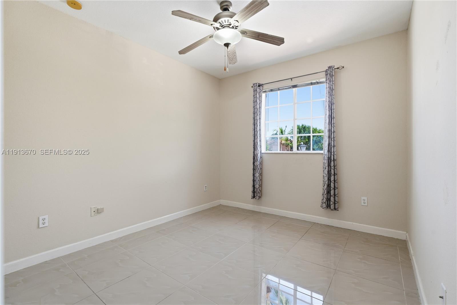 21460 Southwest 85th Passage Cutler Bay, FL 33189 - Photo 11 of 20 an empty room with windows and fan